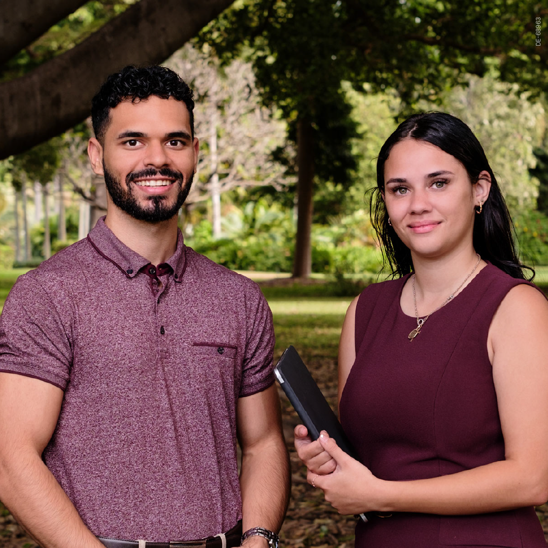 Male and female student standing together and looking at the camera